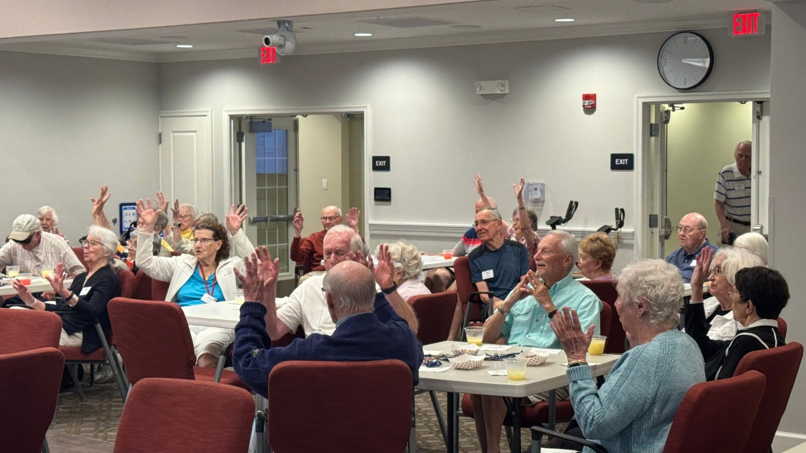 Residents raising hands at a community event