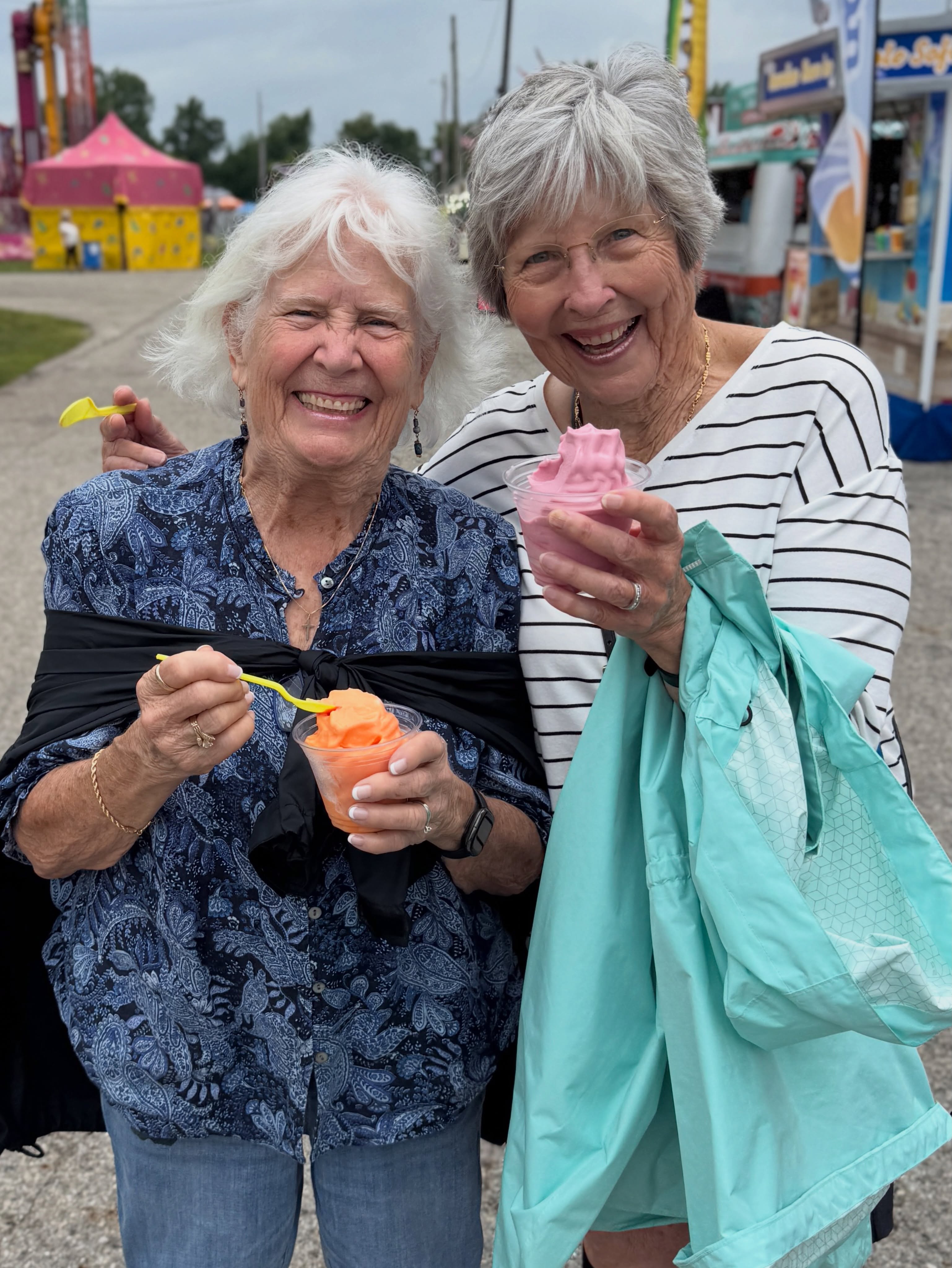 Two residents outdoors with a craft project