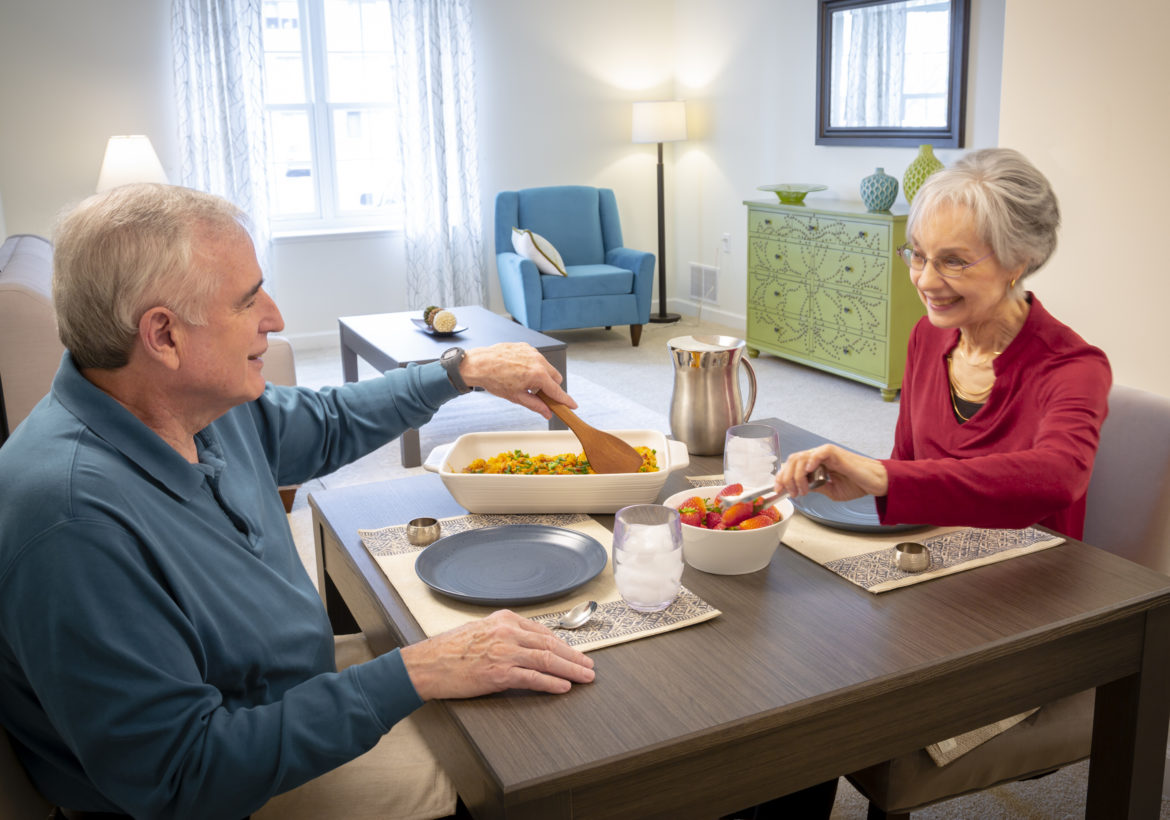 A couple sharing a meal in their apartment home